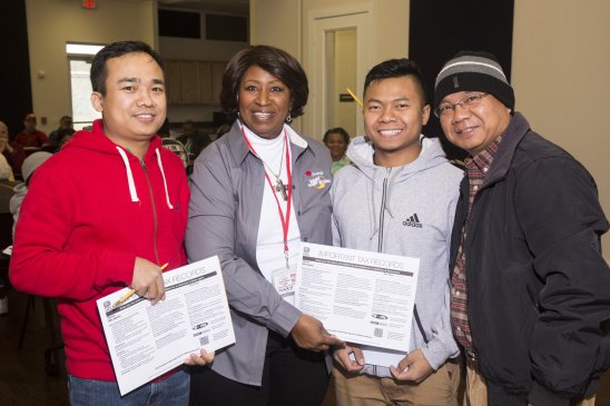 Entergy retiree volunteer Mary Young assists Entergy Texas customers Thang Muang Khup Zo, and Khai K. Pau during this year’s tax season.
